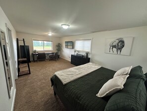 A bedroom with a bed, a desk, a chair, a radiator, a dresser, and a window. - 3 Bedroom Farmhouse with great central location and ease of travel. (Snohomish)