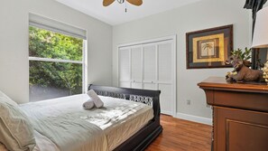 A bedroom with a bed, a window, a wardrobe, and a dresser. - A Peaceful Paradise by Avantstay Screened Pool + Outdoor Kitchen + Fire Table 15 Min to 5th Ave (Naples)