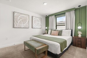 A bedroom with a bed, a bench, two wall-mounted lamps, and a window with curtains. - 3 BD/ 3 BA/ The Hub at Westside Reserve - 3209 ED (Kissimmee)