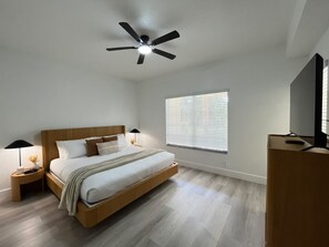 A bedroom with a bed, nightstands, a ceiling fan, a window with blinds, and a TV stand. - 3 BD/ 2 BA/ WorldQuest Resort (4-102 WB) (Orlando)