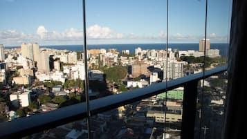 A cityscape with buildings and a body of water in the distance.