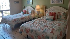 A hotel room with two beds, a window, and artwork on the walls. - Beach view unit  504 (Longboat Key)