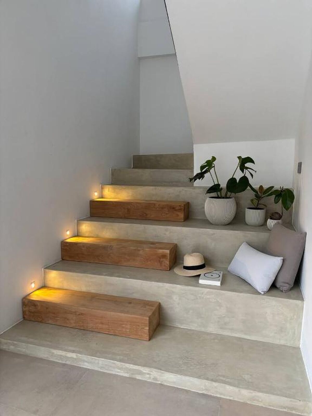 A staircase with wooden steps and built-in lighting.