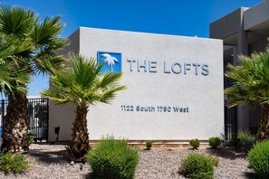 A building with a sign reading 'THE LOFTS' and an address '1122 South 1790 West'. - Poolside Family Retreat, Sleeps 14 (St. George)