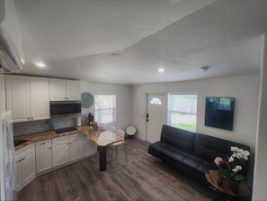 A compact living space with a kitchenette, a dining area, and a seating area. - Private Naples Guesthouse with Pool Near Beaches (Naples)