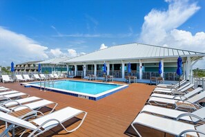 A pool area with lounge chairs and umbrellas on a cruise ship deck. - 🐾 Supplication | Pet Friendly Townhome at Lost Key Golf and Beach Club (Perdido Key)