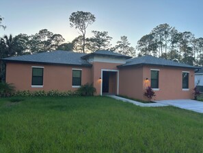 A two-story house with a flat roof, a front door, and a small porch. - Enjoyable 5-bedroom house with AC in charming Naples (Naples)