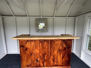 A wooden reception desk with a 'Welcome to The Beach' sign above it. - Waterfront home w/cabana, kayaks and beach! (New Fairfield)