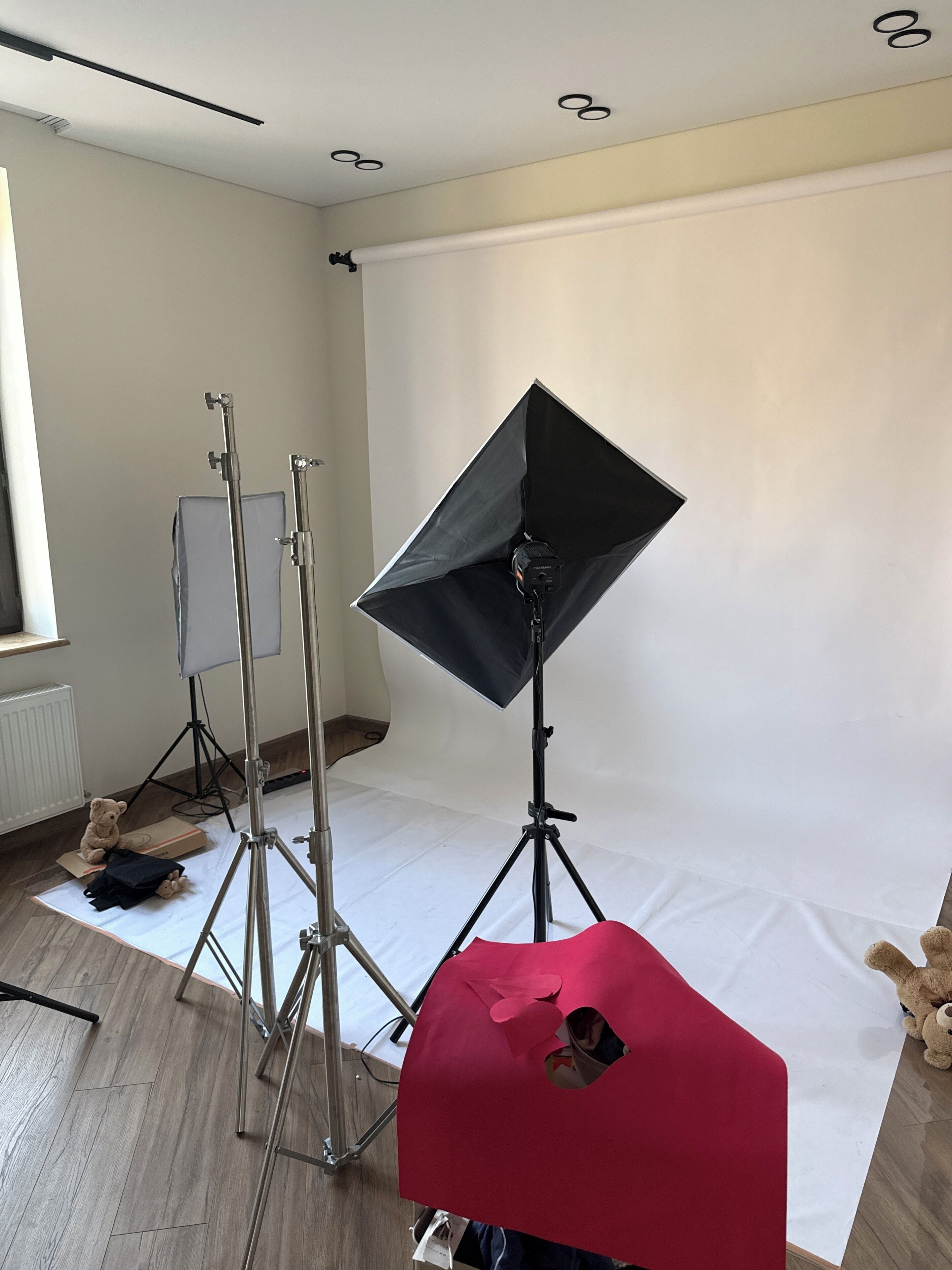Un studio équipé de matériel d’éclairage et d’un fond, ce qui indique un espace dédié à la photographie ou à la vidéographie.