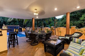 An outdoor patio with a pool, lounge chairs, and a dining table. - Jungle Pool Villa - 5BR Gated Playacar Hideaway (Playa del Carmen)