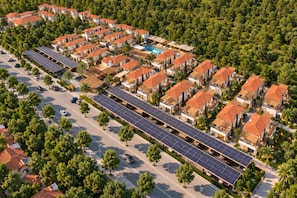 A residential area with multiple houses, a swimming pool, and solar panels. - Ramada Resort By Wyndham Datca (Datca)