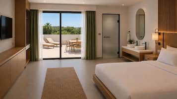A hotel room with a bed, a desk, a TV, and a balcony with a view of greenery.