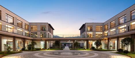 A modern building with a central courtyard, multiple floors, and large windows.