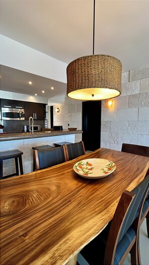 A modern kitchen with a built-in oven, microwave, and stainless steel cabinets. - Aldea Thai PH - Private Oceanfront Pool - Entire condo in Playa del Carmen (Playa del Carmen)