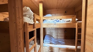 A wooden bunk bed room with a ladder and a small shelf. - Balcony, tv, ski locker, 50m², Chamrousse (Chamrousse)