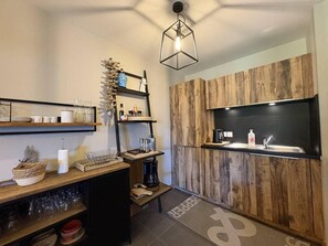 A compact kitchen with wooden accents, a coffee machine, and a hanging light fixture. - 50m from ski slopes, 4th floor, balcony, tv, ski locker, 91m², Valmorel (Les Avanchers-Valmorel)