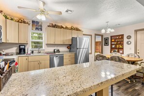 A modern kitchen with granite countertops, stainless steel appliances, and wooden cabinets. - 3-bedroom house in peaceful Checotah right of 69 Highway. (Checotah)