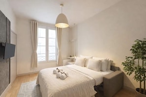 A modern bedroom with a bed, bedside table, and a potted plant. - Family Appartment off Champs Elysees by Melvane (Paris)