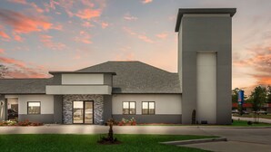 A modern building with a flat roof, large windows, and a prominent vertical structure. - Work, Rest & Recharge Near Pasadena l 2 Queen Suite w/ Kitchen (Deer Park)