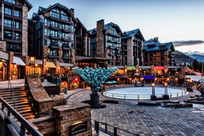 A hotel with multiple floors, a central courtyard, and a large decorative sculpture. - Solaris PHFW - 3 Bedroom + Den (Vail)