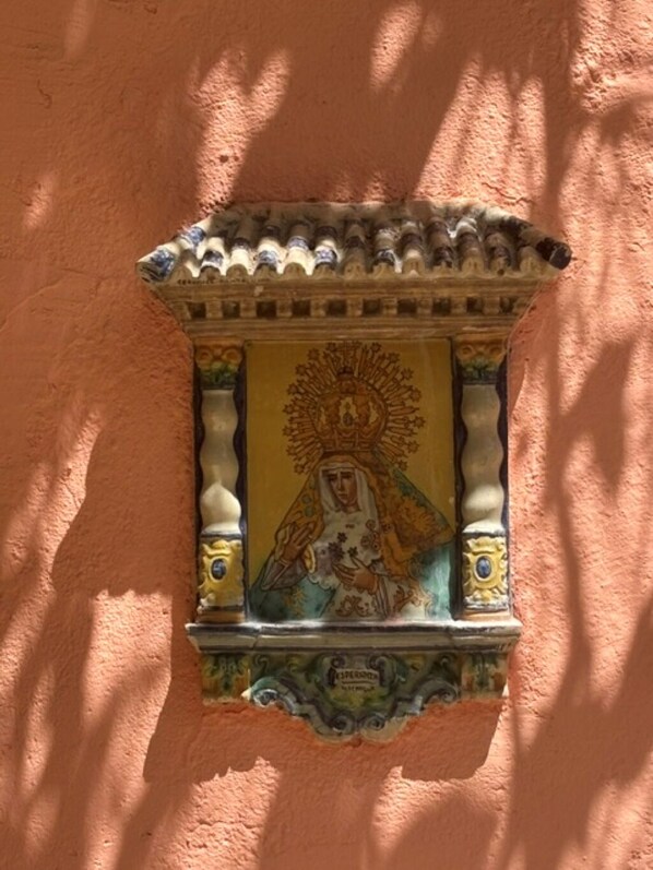 A wall-mounted decorative panel with a religious figure, ornate border, and a tiled roof. - Historic Waterfront Villa with Dock, Private Pool and Caribbean Charm (Cartagena)