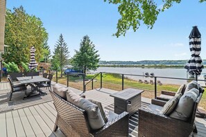 An outdoor deck with seating and a view of a lake. - Gun Lake Beachfront, Pet-Friendly Home w Dock (Free Soil)
