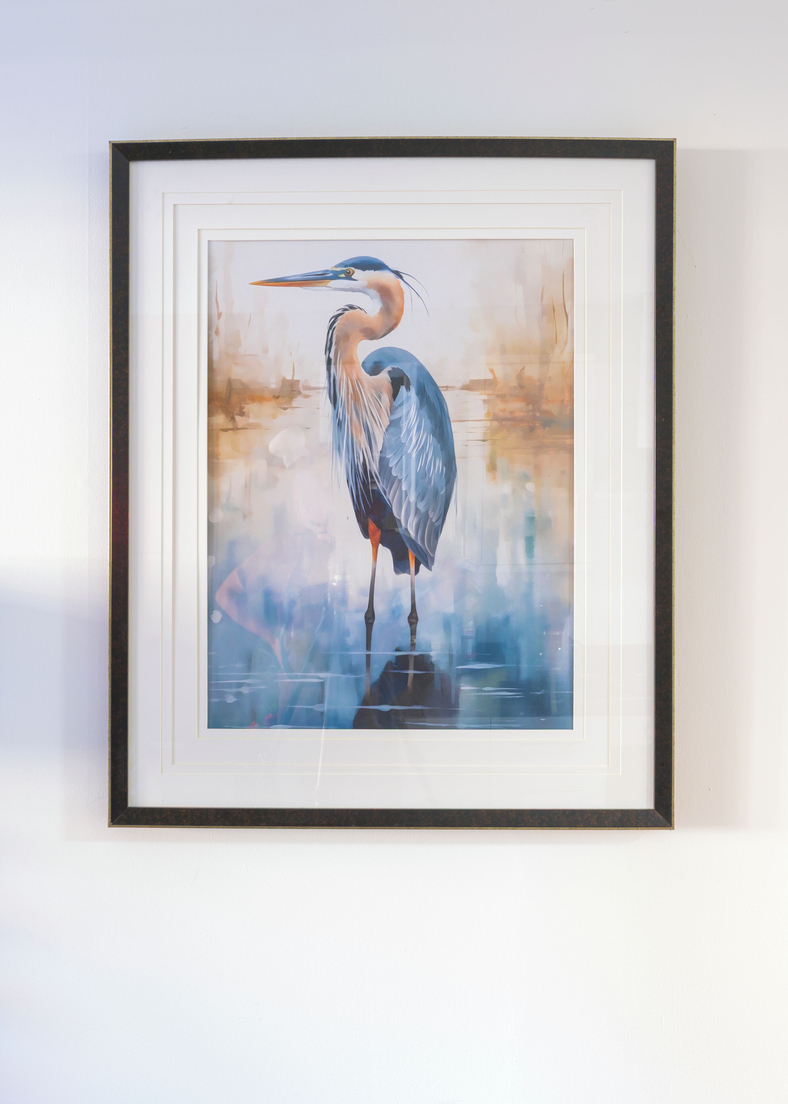 A framed artwork of a heron standing by water.