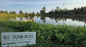 A sign indicating no pond access, no swimming, and no fishing.