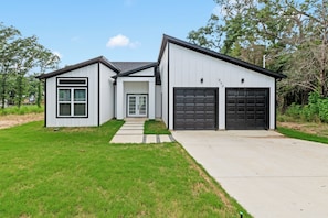 A modern two-story house with a garage and a front porch. - EPIC Fun: Game Room, New Lake View 3BD, RaceTrack! (Gun Barrel City)