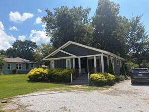 A single-story house with a porch and a driveway.