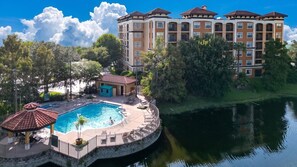 A hotel with a swimming pool, a small gazebo, and a river. - 3BR Orlando Resort | Heated Pools | 3 mi Disney (Orlando)