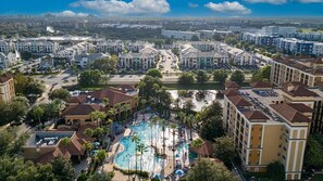 A residential area with a swimming pool surrounded by apartment buildings. - 3BR Orlando Resort | Heated Pools | 3 mi Disney (Orlando)
