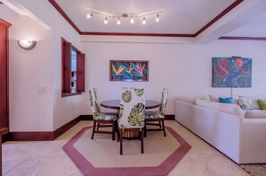 A dining area with a round table, chairs, and a ceiling light fixture. - Salty Breeze Suite|Seaview Family Residence w/Pool (San Pedro)