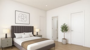 A modern bedroom with a large bed, bedside lamps, a potted plant, and a framed artwork on the wall. - Huntsville Lofts (Huntsville)