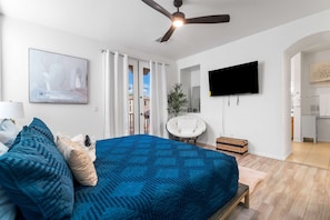 A bedroom with a bed, a ceiling fan, a TV, and a view of the outside. - Phoenix Luxe! Stylish Home! Pool & Hot Tub! Gated community (Phoenix)