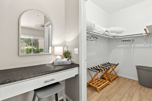 A modern bathroom with a granite countertop, a mirror, a towel rack, and a wooden drying rack. - Fountain Hills Retreat!Pool! Hot Tub! Mountain Views! (Fountain Hills)