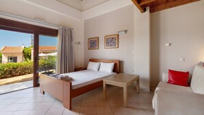 A bedroom with a bed, a bedside table, a chair, and a view of the outdoors. - Villa 'Kalirroe' in Marathiás (Marathiás)