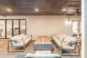 A modern living room with a central table, two sofas, and a glass partition. - NEW|The Belmont @ Kierland |Updated Oasis w/Pool (Scottsdale)