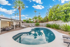 A backyard with a swimming pool, lounge chairs, and a covered patio area. - NEW|The Belmont @ Kierland |Updated Oasis w/Pool (Scottsdale)