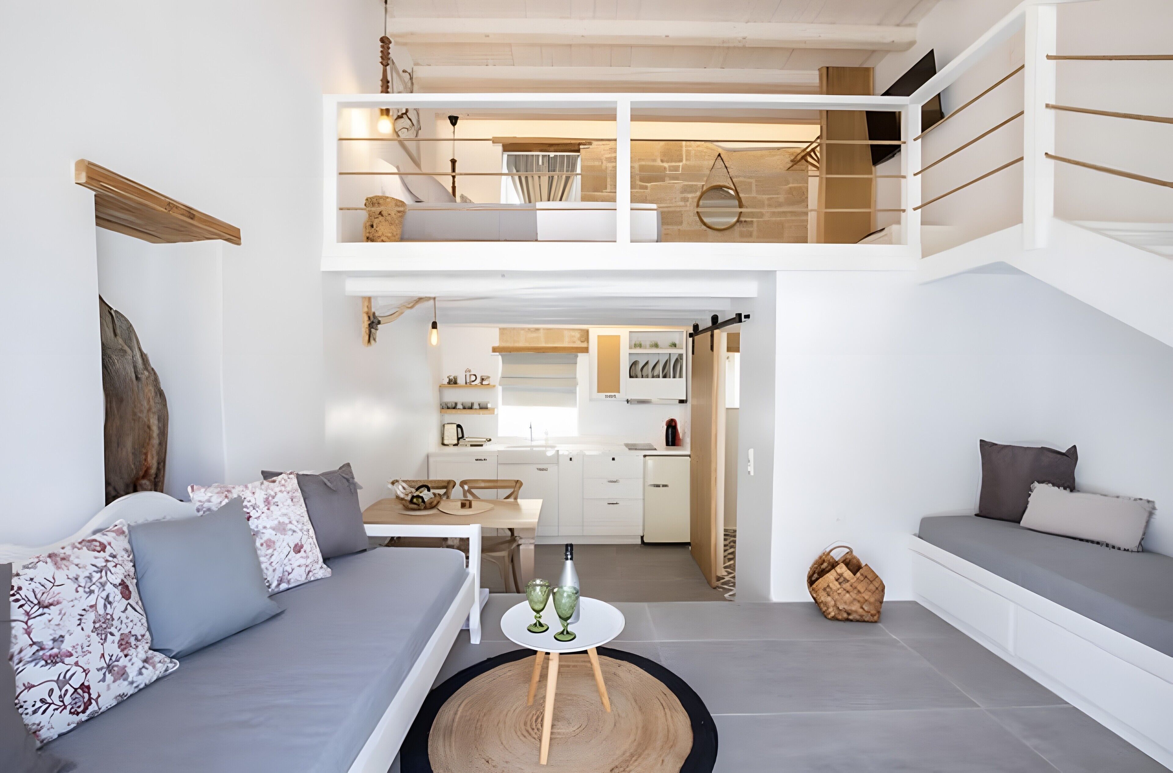 A modern apartment with a loft bedroom, a dining area, and a kitchen.