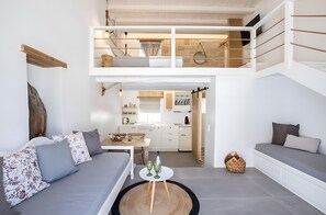 A modern apartment with a loft bedroom, a dining area, and a kitchen. - Villa 'Grannys Finiki' with Mountain View, Wi-Fi and Air Conditioning (Karpathos)