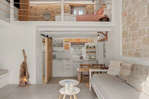 A two-story apartment with a loft bedroom, a dining area, and a kitchen. - Villa 'Grannys Finiki' with Mountain View, Wi-Fi and Air Conditioning (Karpathos)