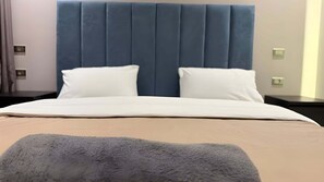 A bed with a headboard, two pillows, and a blanket. - Cozy 1-bedroom studio in charming Casablanca with AC (Casablanca)
