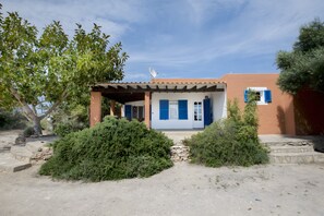 A two-story building with a flat roof, a covered porch, and a satellite dish. - Casa Rita in Formentera with Sea Views (Sant Ferran de ses Roques)