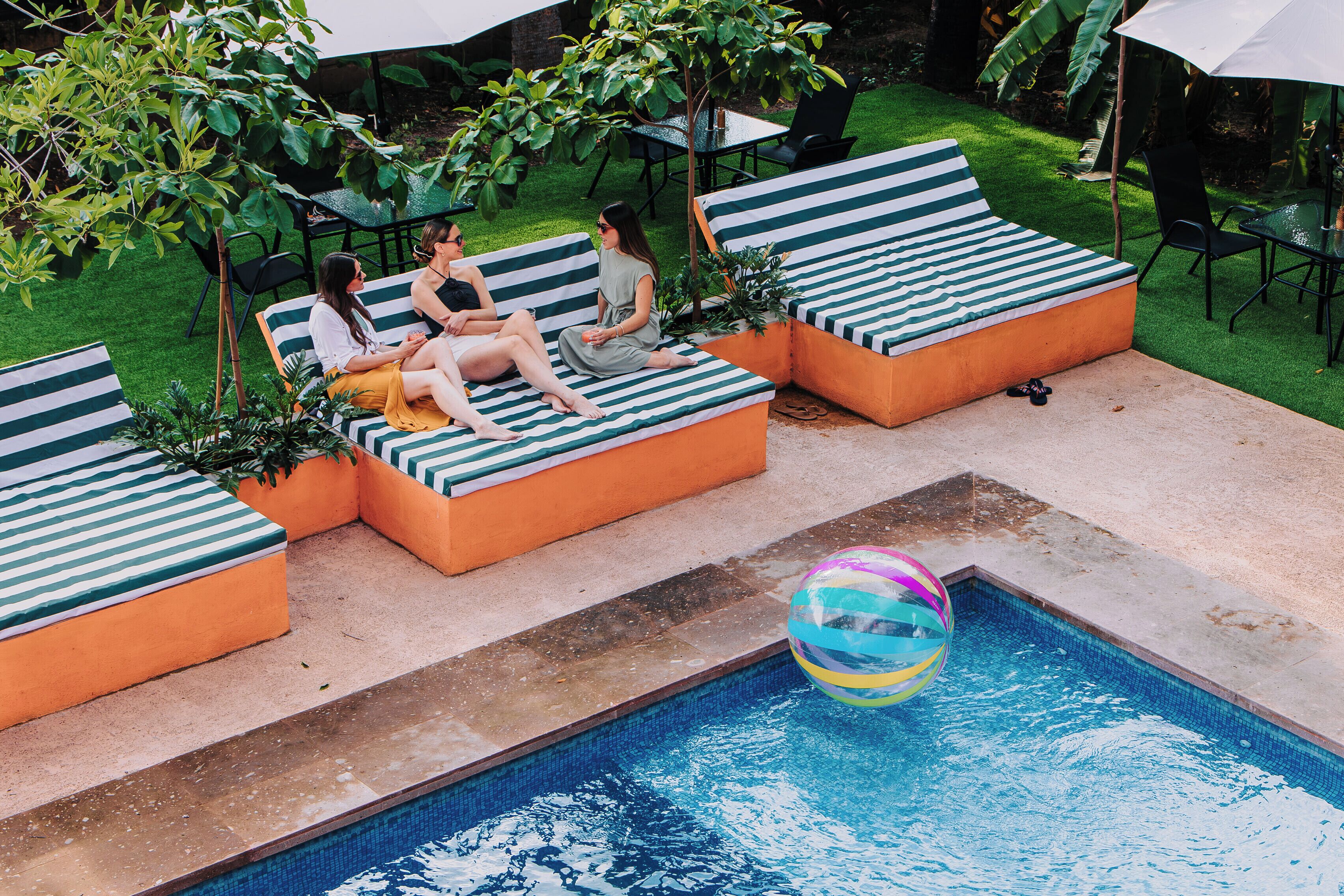 A poolside area with lounge chairs and a pool.