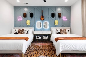 A bedroom with two beds, a mirror, and a guitar on the wall. - Rooftop Rodeo • Hot Tub, FirePit • 3mi to Broadway (Nashville)