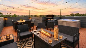 An outdoor patio with a grill, seating, and a hot tub. - Rooftop Rodeo • Hot Tub, FirePit • 3mi to Broadway (Nashville)