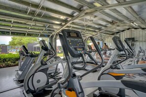 A covered outdoor gym area with multiple stationary exercise bikes and treadmills. - Kiahuna Hale Kai I (Koloa)