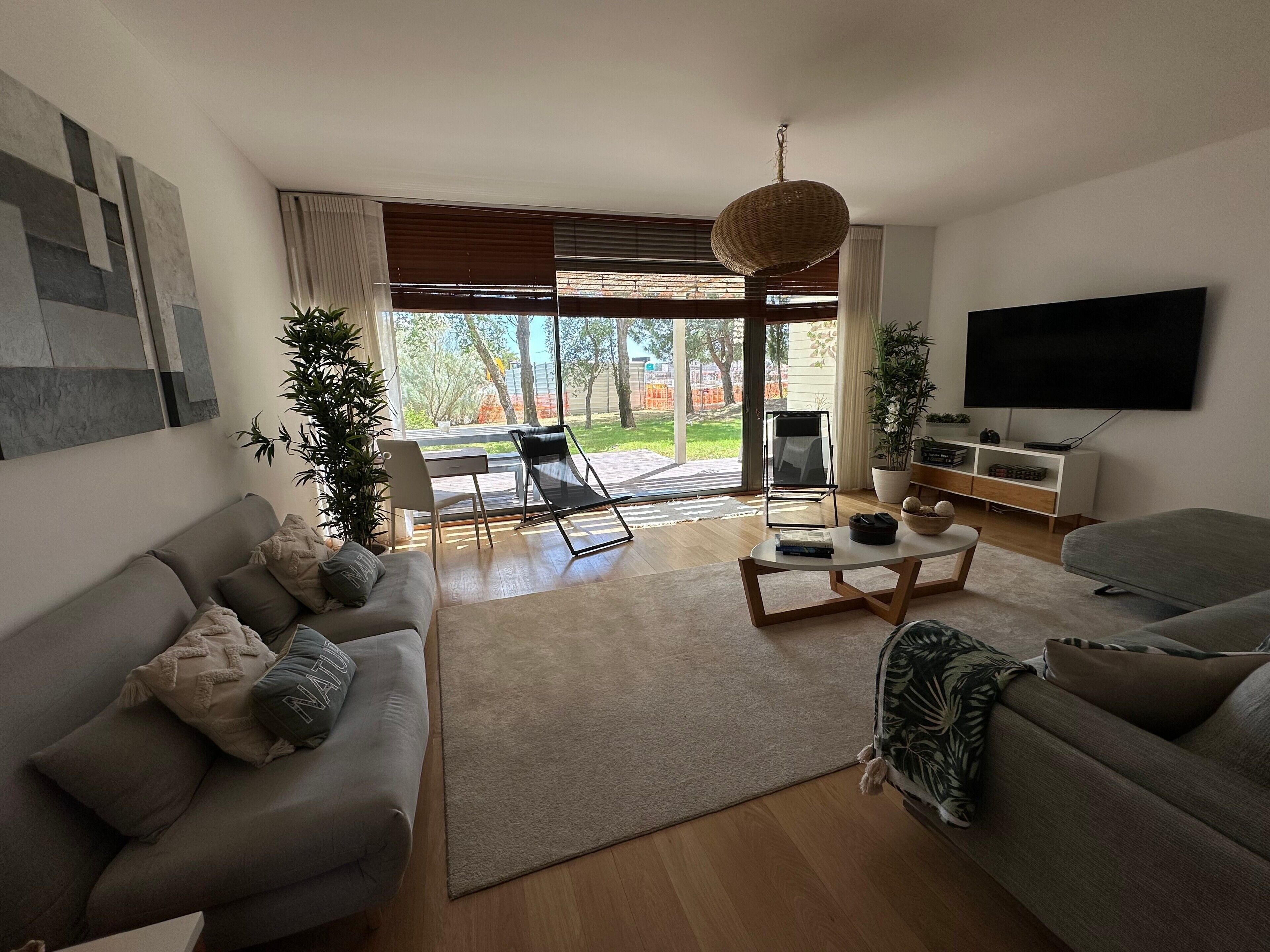 A modern living room with a sofa, coffee table, and a TV.