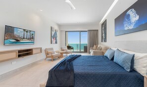 A modern hotel room with a large bed, a desk, a chair, and a balcony with a view. - One 1702A Hotel Room:🌌 Star Wars Oceanfront Hotel Room| Sonoran Star Resort ⭐🌊 (Puerto Peñasco)